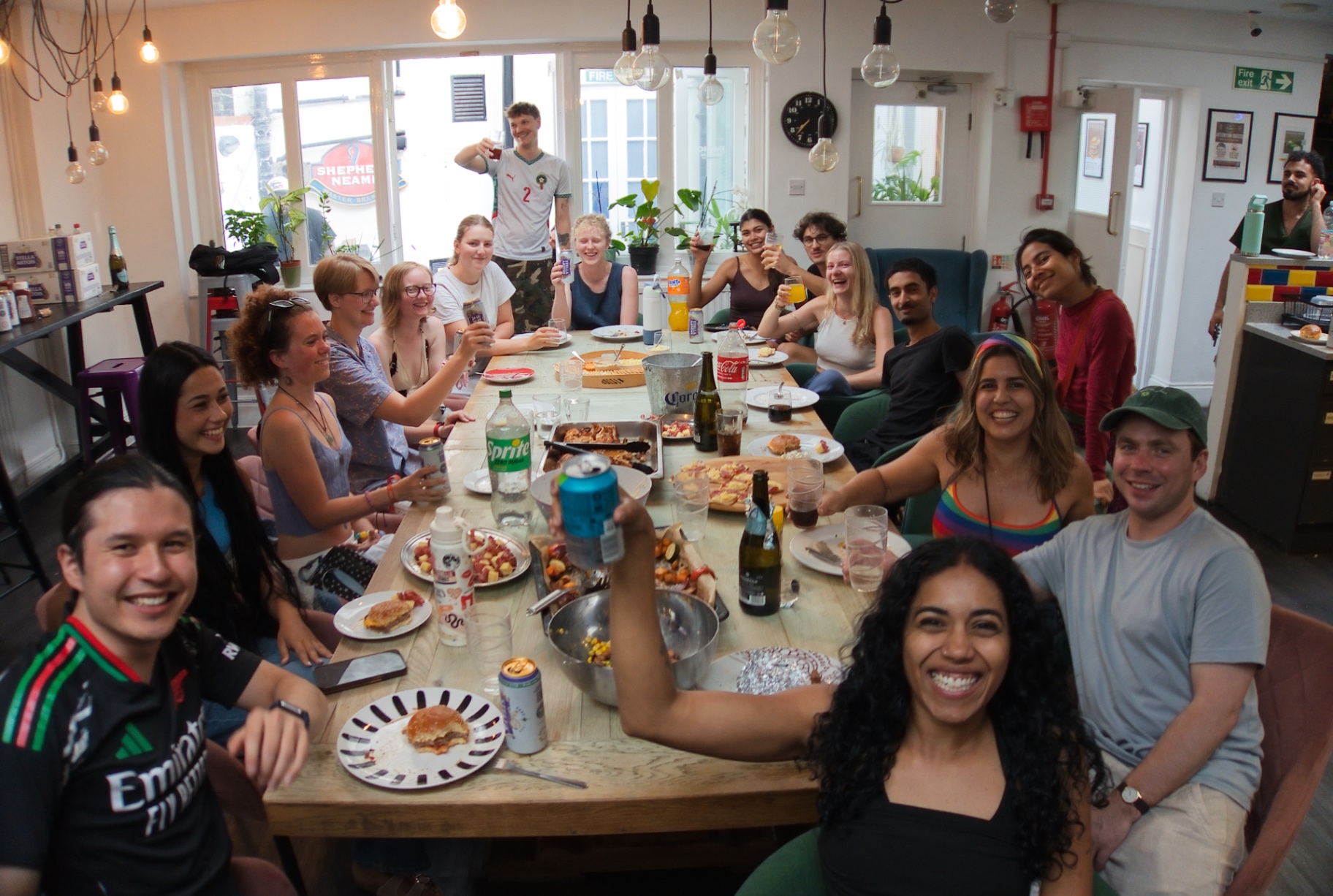 Group of guests cheers-ing around the dinner table